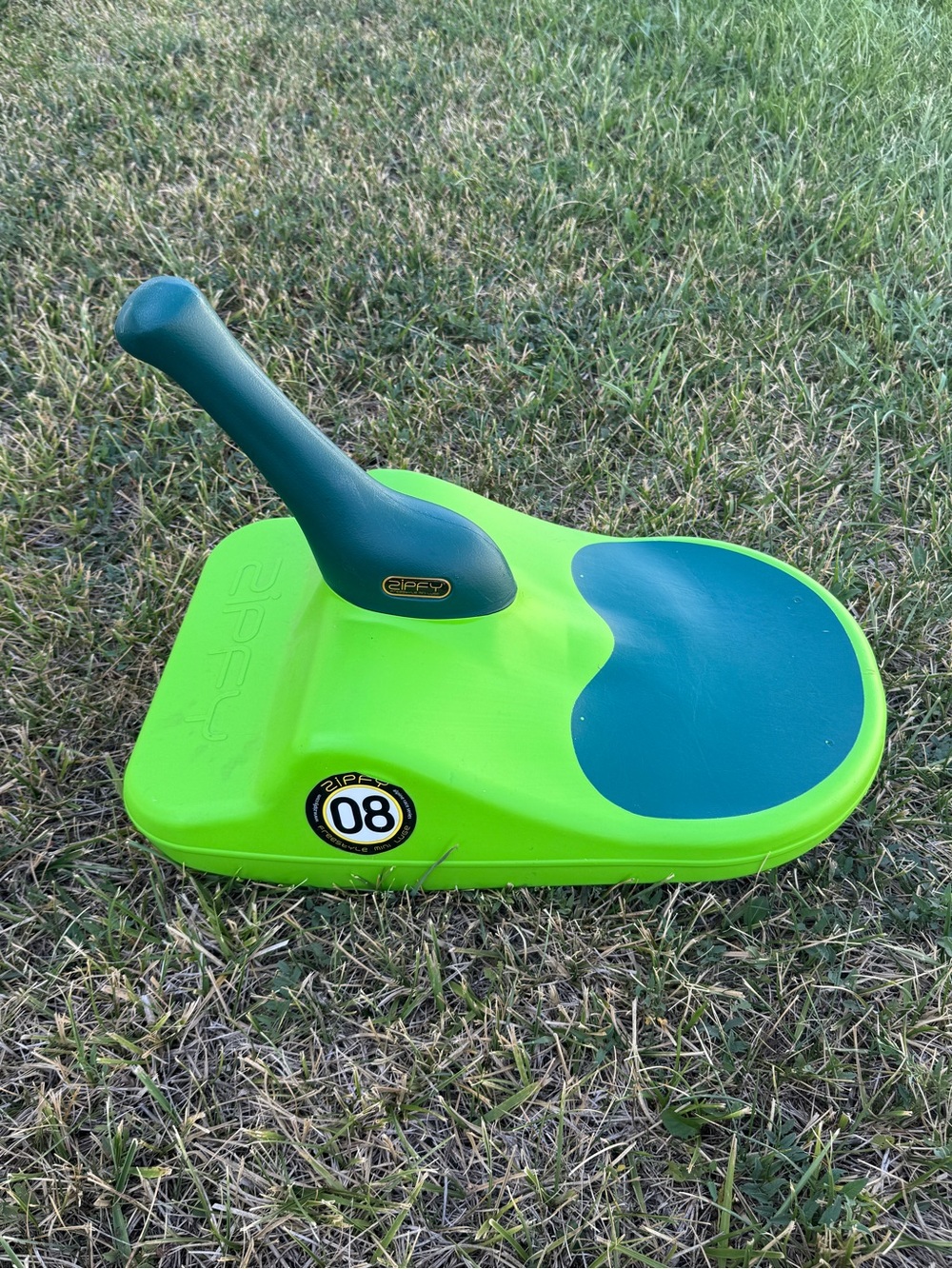Zipfy Lime Green and Teal Kids Ride-On in the snow